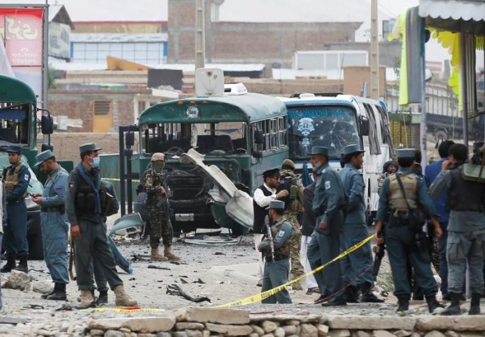Afghan security forces inspect the damage caused by a suicide bombers at the site of the attackon the western outskirts of Kabul